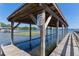 Waterfront property with a covered boat dock featuring a clothing optional area on a picturesque lake at 16047 E Shirley Shores Rd, Tavares, FL 32778