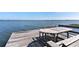 This private dock features a covered gazebo and seating area, perfect for outdoor lakefront dining at 16047 E Shirley Shores Rd, Tavares, FL 32778