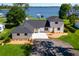 Stunning waterfront home featuring a new roof and a circular driveway leading to its grand entrance at 16047 E Shirley Shores Rd, Tavares, FL 32778