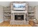 Rustic painted brick fireplace featuring a white mantel and decorative shelving at 16047 E Shirley Shores Rd, Tavares, FL 32778