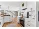 Kitchen view with white cabinets, stainless appliances and modern lighting at 16047 E Shirley Shores Rd, Tavares, FL 32778