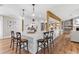 Kitchen island with barstool seating and sleek white countertops at 16047 E Shirley Shores Rd, Tavares, FL 32778