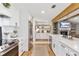 Bright kitchen with white cabinetry, stainless steel appliances, and hardwood flooring at 16047 E Shirley Shores Rd, Tavares, FL 32778