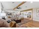 Spacious living room boasting a large sectional sofa, wooden beams, and an open floor plan at 16047 E Shirley Shores Rd, Tavares, FL 32778