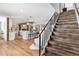 Open concept living space with a staircase leading to the second floor and hardwood flooring throughout at 16047 E Shirley Shores Rd, Tavares, FL 32778