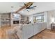 Inviting living room featuring a brick fireplace, wooden beams, and a scenic waterfront view at 16047 E Shirley Shores Rd, Tavares, FL 32778