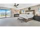 Bright main bedroom with waterfront views, a king bed, and neutral decor at 16047 E Shirley Shores Rd, Tavares, FL 32778