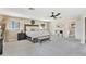 Bright main bedroom with neutral decor, a king bed, fireplace and carpeted flooring at 16047 E Shirley Shores Rd, Tavares, FL 32778