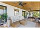 A screened-in lanai featuring a wood ceiling, ceiling fans, plenty of seating, and views of the lake at 16047 E Shirley Shores Rd, Tavares, FL 32778