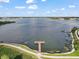 Breathtaking aerial view featuring a private dock on the serene lake under a partly cloudy sky at 16300 County Road 455 # 511, Montverde, FL 34756