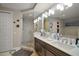 Modern bathroom featuring a double vanity, a glass-enclosed shower, and elegant lighting at 16300 County Road 455 # 511, Montverde, FL 34756