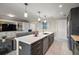 Open kitchen layout with an island, stainless appliances, and living area at 16300 County Road 455 # 511, Montverde, FL 34756