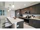 Modern kitchen with island seating, stainless steel appliances, and sleek finishes at 16300 County Road 455 # 511, Montverde, FL 34756