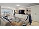 Bright living room showcases a large entertainment center, comfortable seating, and tranquil water views at 16300 County Road 455 # 511, Montverde, FL 34756