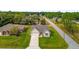 Aerial view of a home in a residential neighborhood with mature trees at 16380 Se 83Rd Ct, Summerfield, FL 34491