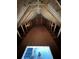 View of an unfinished attic, featuring plywood flooring, rafters, and a peek at the room below through the access hatch at 16380 Se 83Rd Ct, Summerfield, FL 34491