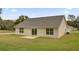A backyard featuring a patio area and plentiful green space at 16380 Se 83Rd Ct, Summerfield, FL 34491