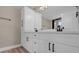 Elegant bathroom with double sinks, black hardware, and modern light fixtures at 16380 Se 83Rd Ct, Summerfield, FL 34491