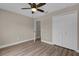 Spacious bedroom with hardwood flooring, ceiling fan and double-door closet at 16380 Se 83Rd Ct, Summerfield, FL 34491