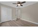 Spacious bedroom with hardwood flooring, ceiling fan and double-door closet at 16380 Se 83Rd Ct, Summerfield, FL 34491