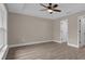 Spacious bedroom with laminate flooring, neutral paint, a ceiling fan, and ample natural light at 16380 Se 83Rd Ct, Summerfield, FL 34491