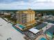 Stunning aerial view of the condo building, showcasing its beachfront location and inviting pool area at 1705 S Atlantic Ave # 502, New Smyrna Beach, FL 32169