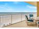 Balcony seating with ocean views, perfect for relaxation and enjoying the coastal scenery at 1705 S Atlantic Ave # 502, New Smyrna Beach, FL 32169