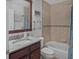 Well-lit bathroom with a granite countertop, tile backsplash, and a shower/tub combo at 1705 S Atlantic Ave # 502, New Smyrna Beach, FL 32169