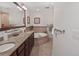 Bright bathroom with double sinks, granite countertops, and a luxurious soaking tub at 1705 S Atlantic Ave # 502, New Smyrna Beach, FL 32169