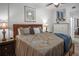 Relaxing bedroom with decorative ceiling fan, a full sized bed, and an adjacent bathroom at 1705 S Atlantic Ave # 502, New Smyrna Beach, FL 32169