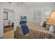 Bright bedroom featuring a comfortable bed, with a flatscreen tv and an ensuite bathroom at 1705 S Atlantic Ave # 502, New Smyrna Beach, FL 32169