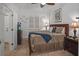 Comfortable bedroom featuring a ceiling fan, tiled floors, and an adjacent bathroom at 1705 S Atlantic Ave # 502, New Smyrna Beach, FL 32169