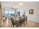 Dining area with seating for four, leading to a comfortable living room and ocean view balcony at 1705 S Atlantic Ave # 502, New Smyrna Beach, FL 32169