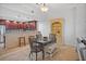 Open dining area featuring views of the modern kitchen with breakfast bar seating at 1705 S Atlantic Ave # 502, New Smyrna Beach, FL 32169