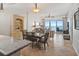 Open-concept living and dining area with a large window offering ocean views at 1705 S Atlantic Ave # 502, New Smyrna Beach, FL 32169