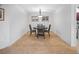 Minimalist dining room featuring a round table, modern lighting, and tile flooring throughout at 1705 S Atlantic Ave # 502, New Smyrna Beach, FL 32169