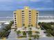Beautiful exterior view of a resort complex with ocean views and lush tropical landscaping at 1705 S Atlantic Ave # 502, New Smyrna Beach, FL 32169