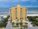 Beautiful beachfront condo building featuring ocean views and tropical landscaping at 1705 S Atlantic Ave # 502, New Smyrna Beach, FL 32169