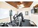 Inviting fitness center with wood-paneled ceiling, offering modern elliptical and treadmill equipment at 1705 S Atlantic Ave # 502, New Smyrna Beach, FL 32169