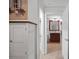 Bright hallway leading to a full bathroom with a dark vanity at 1705 S Atlantic Ave # 502, New Smyrna Beach, FL 32169