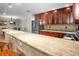 Spacious kitchen featuring granite countertops, stainless appliances, dark wood cabinetry and a breakfast bar at 1705 S Atlantic Ave # 502, New Smyrna Beach, FL 32169