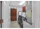 Bright laundry room featuring tile floors, wooden cabinet, washer, dryer and utility sink at 1705 S Atlantic Ave # 502, New Smyrna Beach, FL 32169