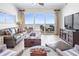 Bright living room with sliding glass doors leading to a balcony overlooking the ocean at 1705 S Atlantic Ave # 502, New Smyrna Beach, FL 32169
