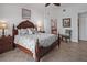 Inviting bedroom with decorative ceiling fan, en suite bathroom, and warm lighting at 1705 S Atlantic Ave # 502, New Smyrna Beach, FL 32169