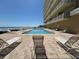Resort-style pool and lounge chairs overlook the ocean, creating a luxurious and serene retreat at 1705 S Atlantic Ave # 502, New Smyrna Beach, FL 32169