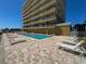 Outdoor pool area featuring comfortable lounge chairs in front of the building, perfect for relaxation at 1705 S Atlantic Ave # 502, New Smyrna Beach, FL 32169