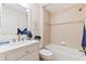 Bright bathroom featuring a shower-tub combination and single sink vanity with decorative mirror at 1716 Bugle Ter, The Villages, FL 32162