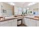 Bathroom with double vanity sinks, ample cabinet space, and a bright, neutral color palette at 1716 Bugle Ter, The Villages, FL 32162