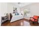 Cozy bedroom with stylish daybed, accent chair, and natural light from the window at 1716 Bugle Ter, The Villages, FL 32162
