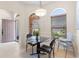 Bright breakfast nook featuring a glass table set and two arched windows at 1716 Bugle Ter, The Villages, FL 32162